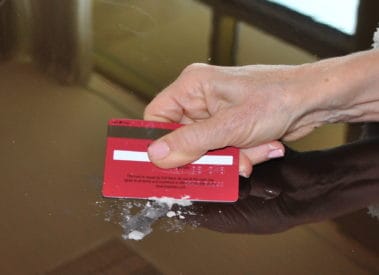 Use a Credit Card carefully to Remove Wax